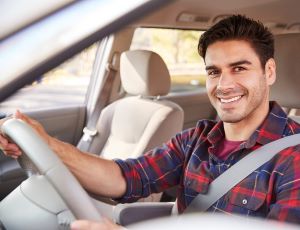 Smiling young driver behind the wheel